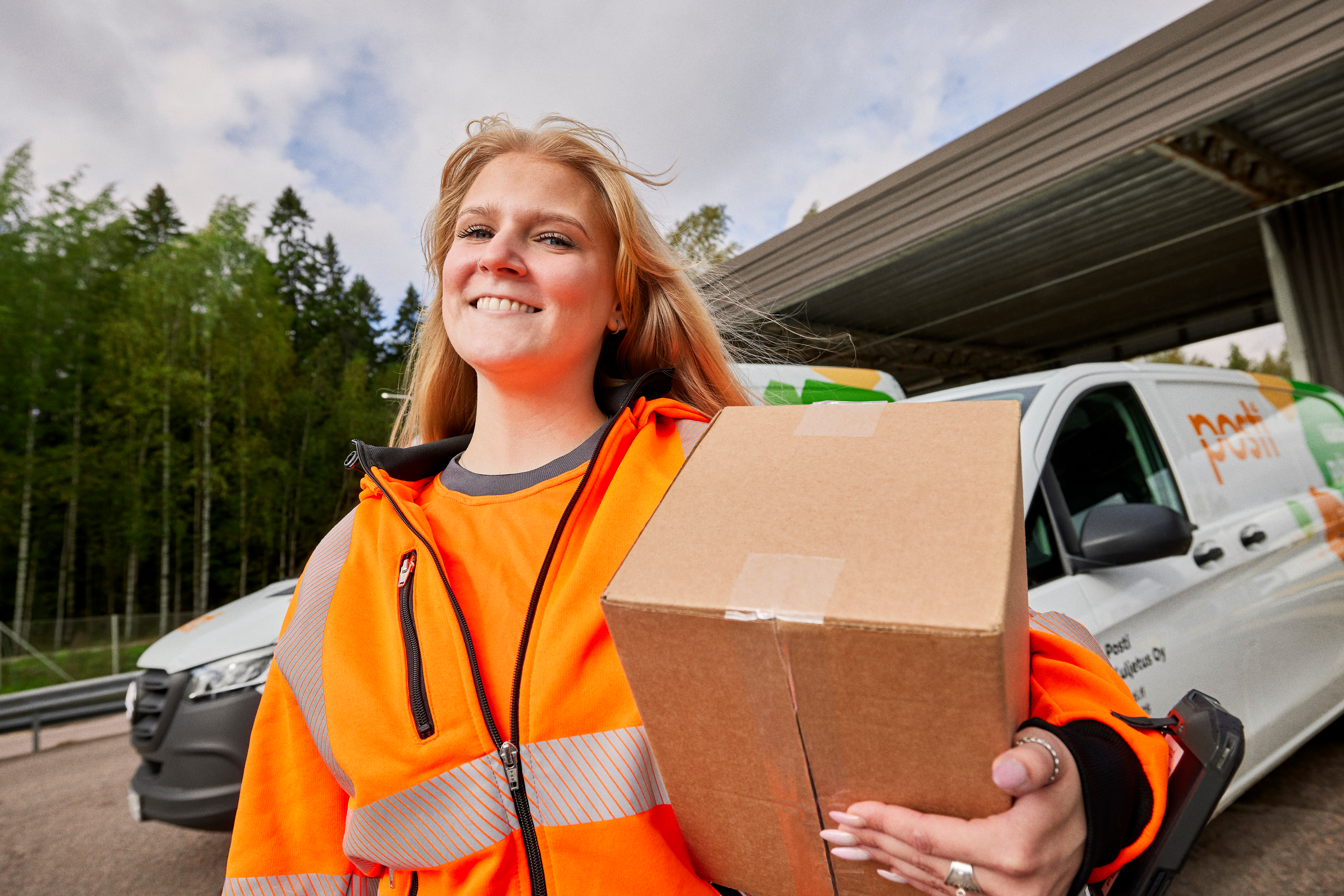 A woman carrying a parcel.
