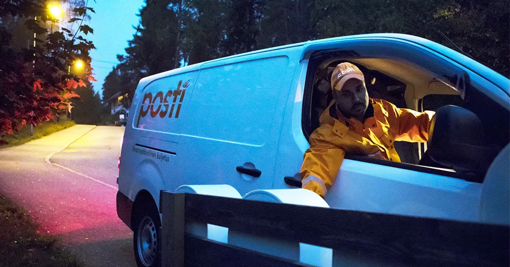 A man delivering mail in early delivery.