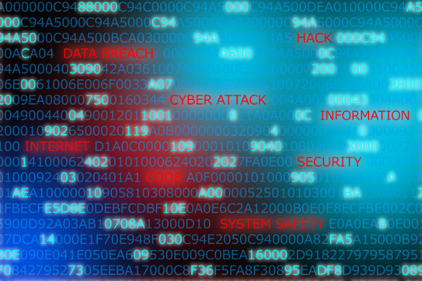 A visual representation of hacked data that includes words related to data breaches including: cyber attack, data breach, and system safety.