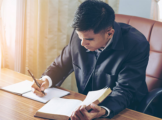 Law student at desk studying for the bar exam