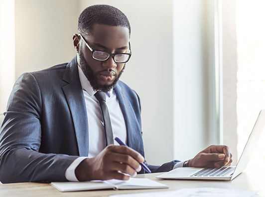 Law professional at desk with laptop