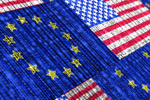 The EU and U.S. flags are seen as binary data streams.