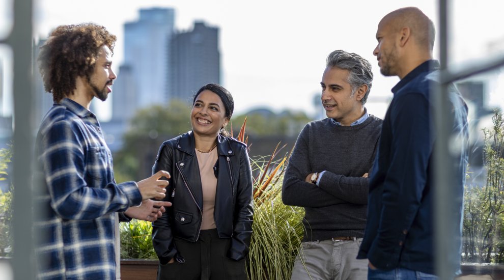 A group of colleagues taking a break and chatting outside.