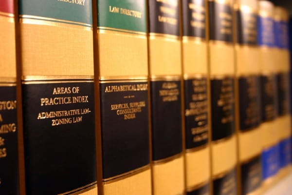 Law books fill a bookcase in a law office.