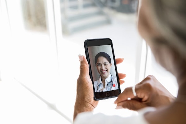 Patient talking to doctor on cell phone video call