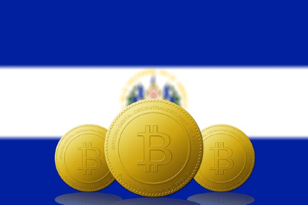 Three Bitcoins with El Salvador flag on background