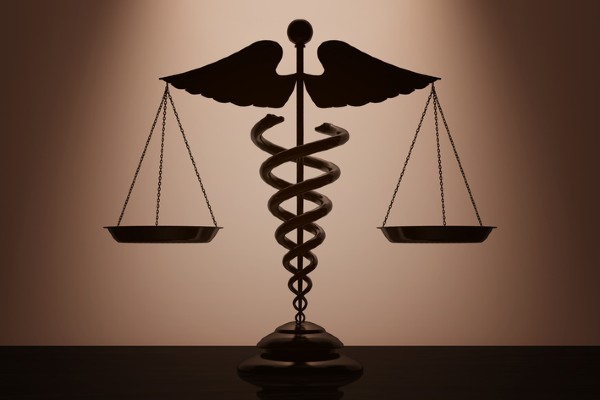 Medical caduceus symbol and the scales of justice
