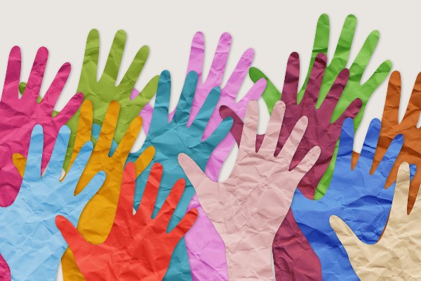 A collage of different-colored hands represents diversity.