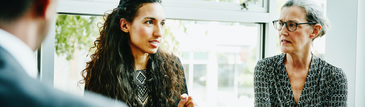 Woman talking to colleagues in conference room