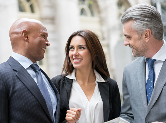 group of three lawyers outside a courthouse