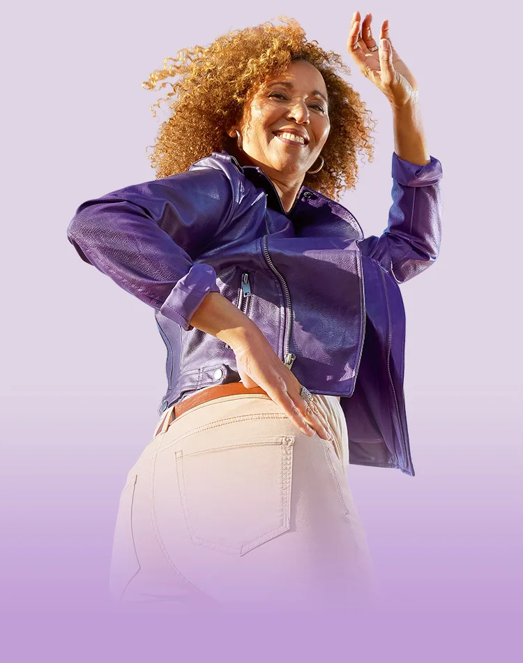 A woman smiling and glancing backward.