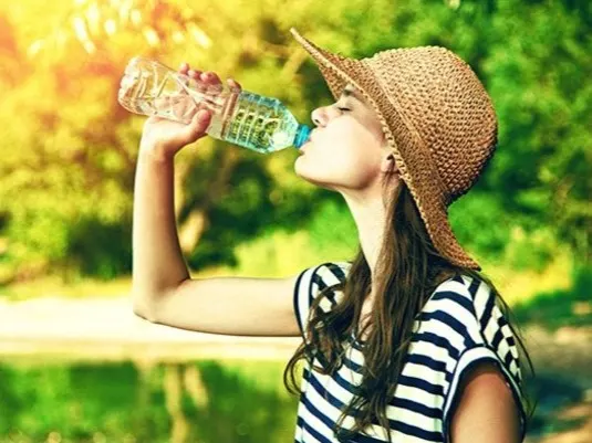 Young woman drinking water from a bottle