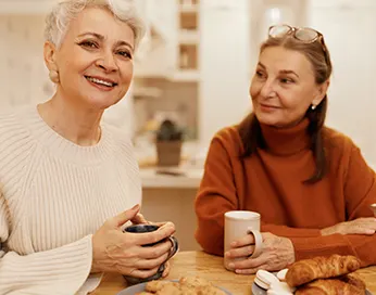 Two middle-aged women drinking tea