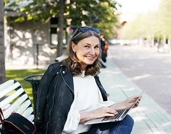 Smiling middle aged woman with laptop