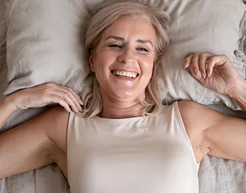 Lying smiling middle-aged woman