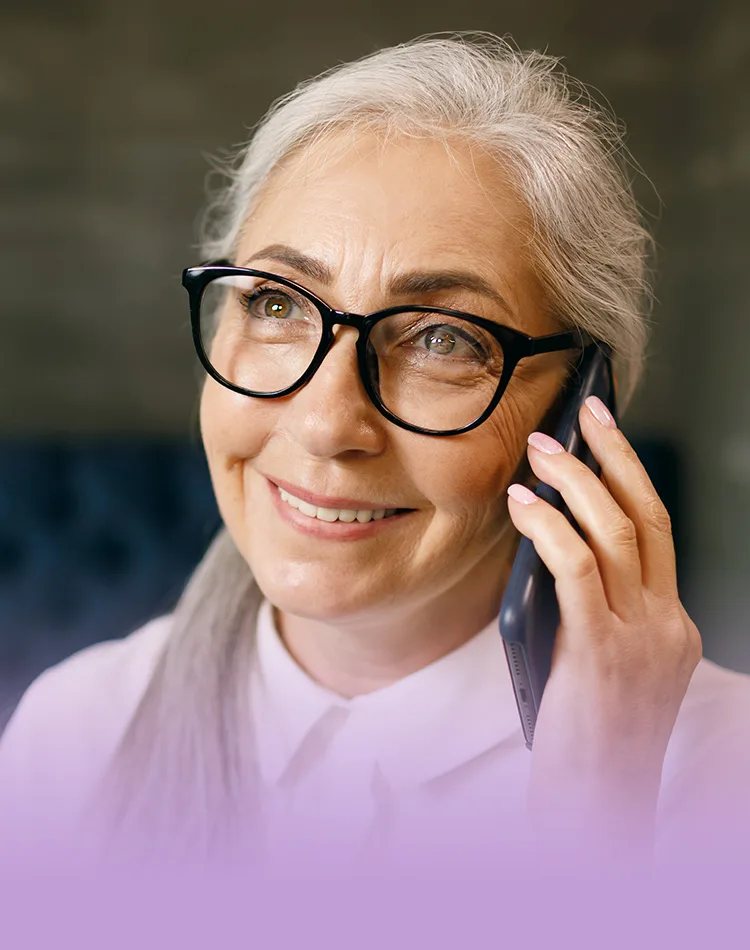 Smiling middle-aged woman talking on a mobile phone