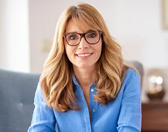 Brown haired middle aged woman with the glasses
