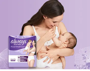  A woman wearing postpartum panties holding a newborn baby in her arms
