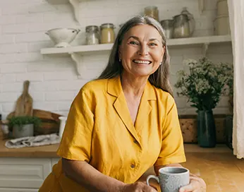 Smiling middle-aged woman in the kitchen