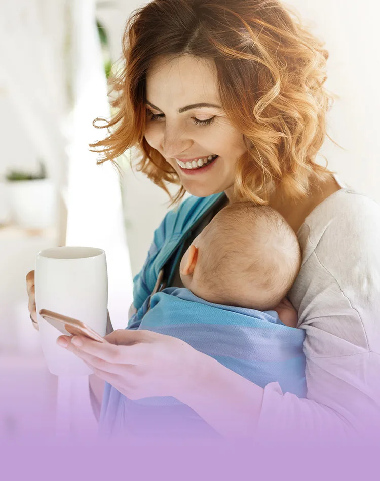 Smiling woman with a newborn baby in her arms