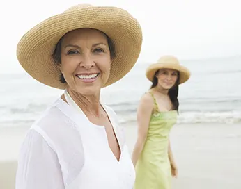 Two smiling women on the beach