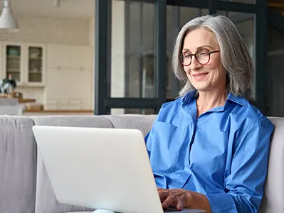 Smiling middle aged woman with laptop