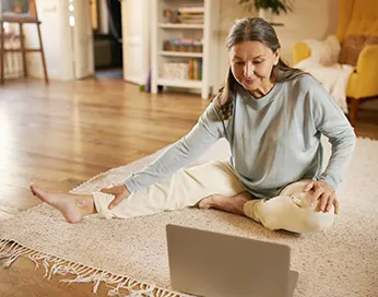Middle aged woman practicing on the floor
