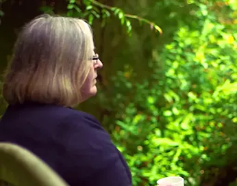 Helen Watts sitting outdoors
