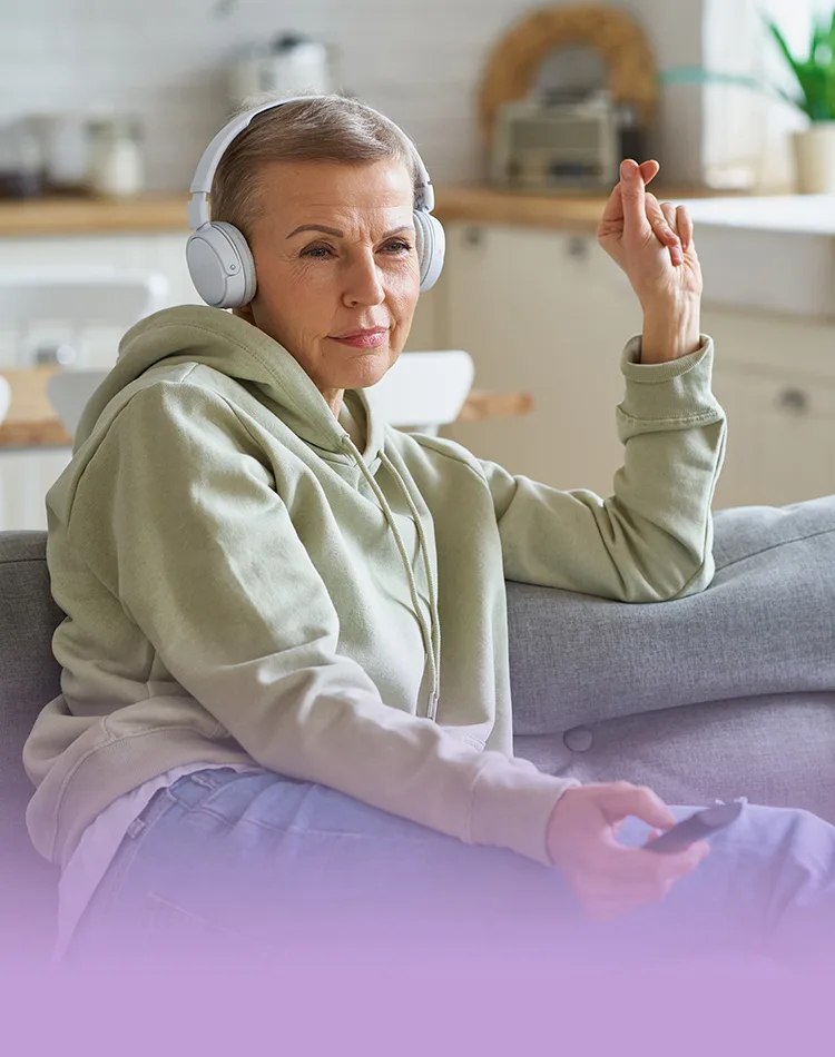 Middle-aged woman with headphones on her ears