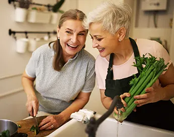 Two laughing women in the kitchen