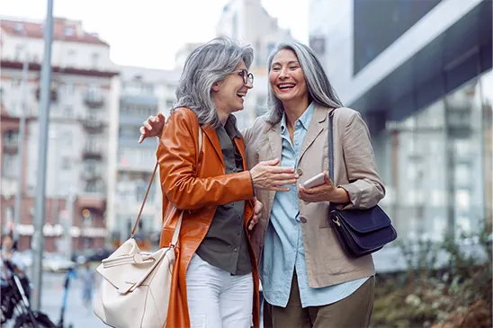Two laughing middle-aged women