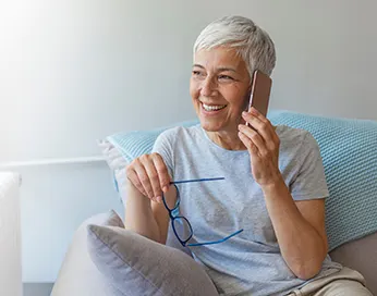 Smiling middle-aged woman talking on a mobile phone