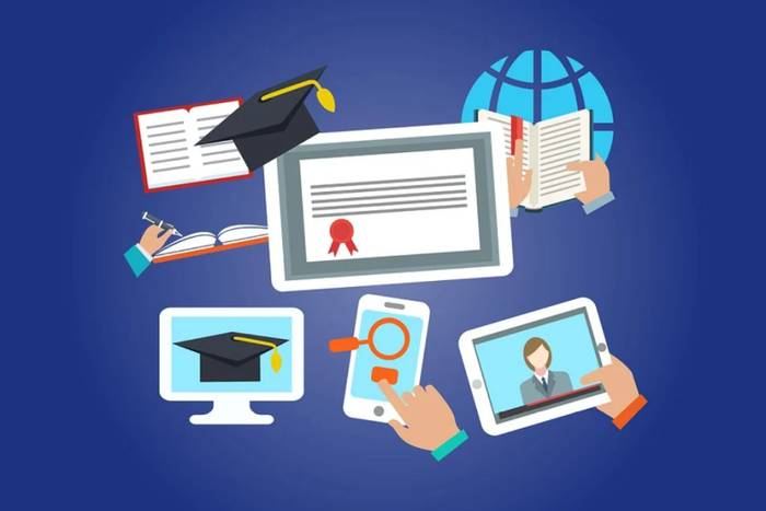 Table of tablets and phones surrounding a graduation cap