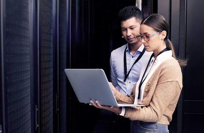 People standing with laptop in hand