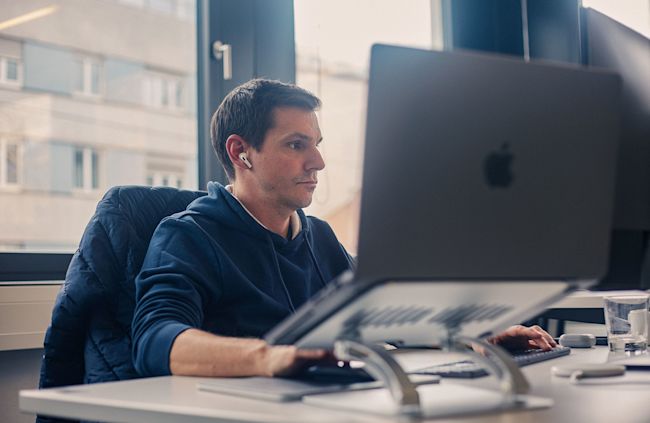 Software architect at work before computer