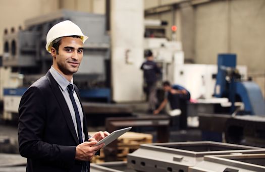 Man with tablet in production hall