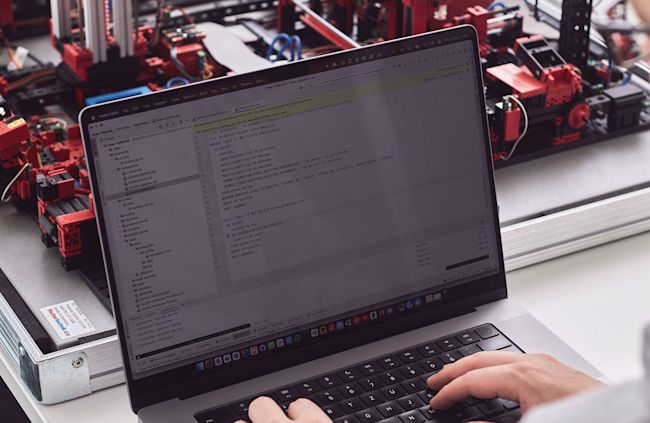 Man working on laptop and implementing an IoT strategy