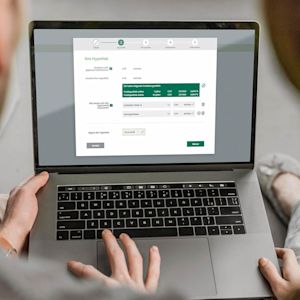 Couple choosing online mortgage on laptop