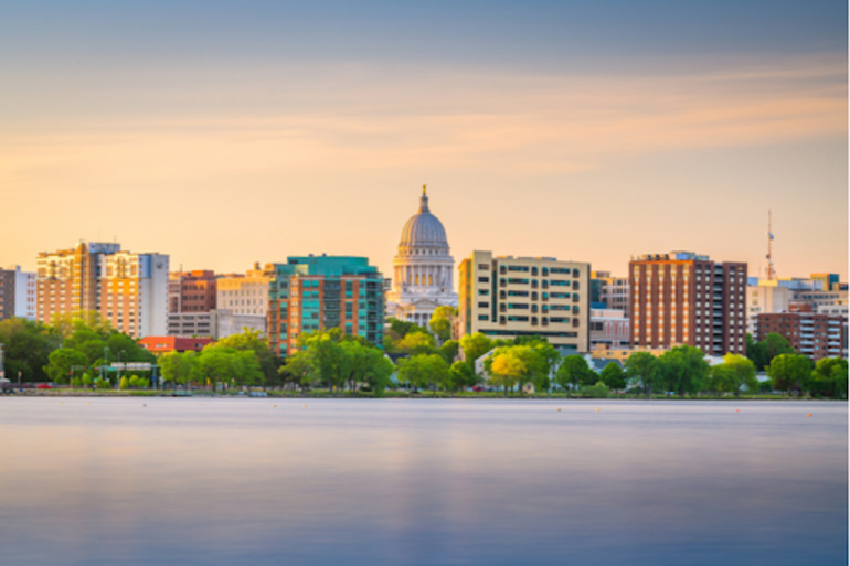 Skyline of Madison, Wisconsin across a lake at sunset