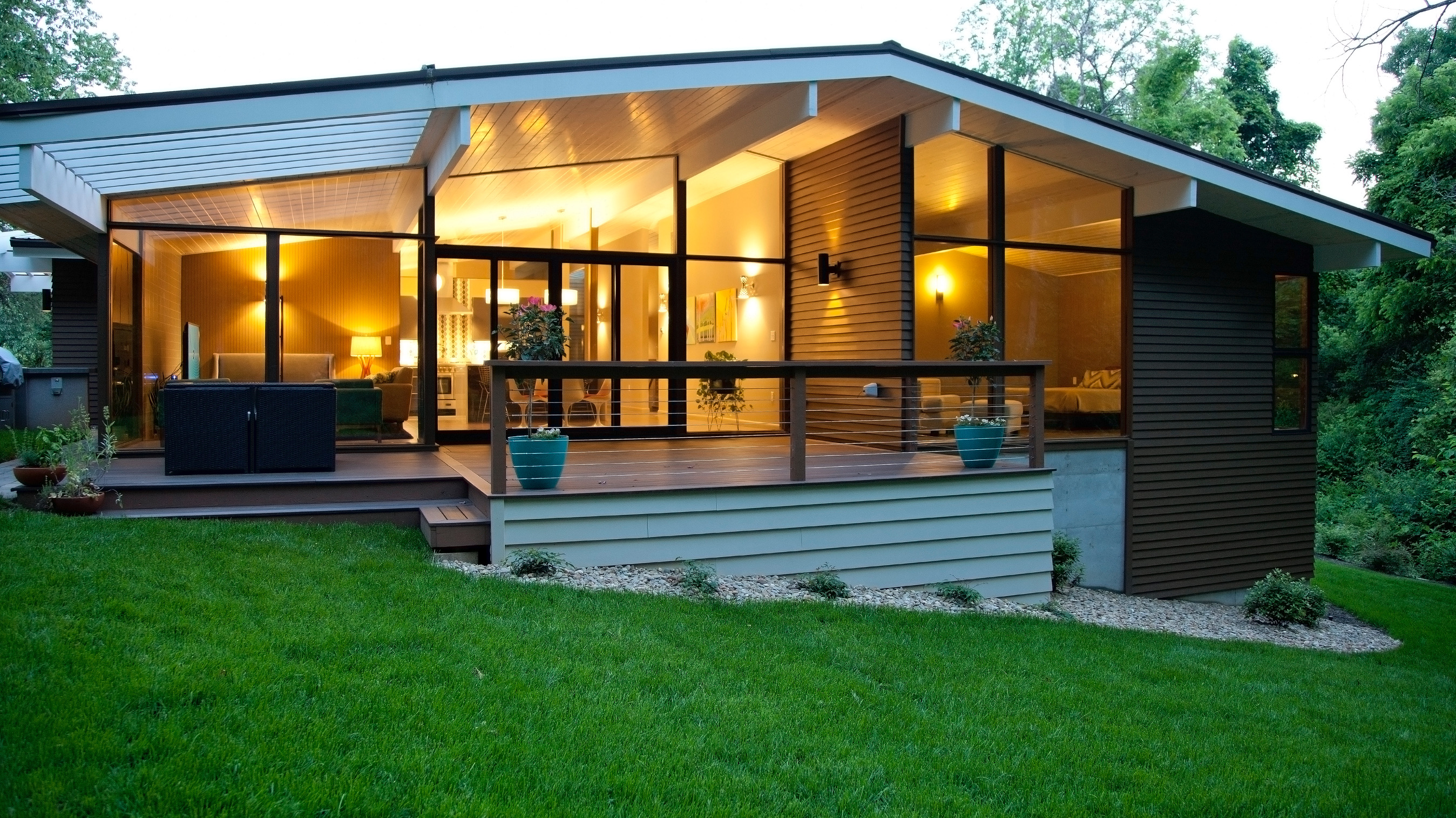 House featuring Artisan® lap siding and large, wall-to-wall windows