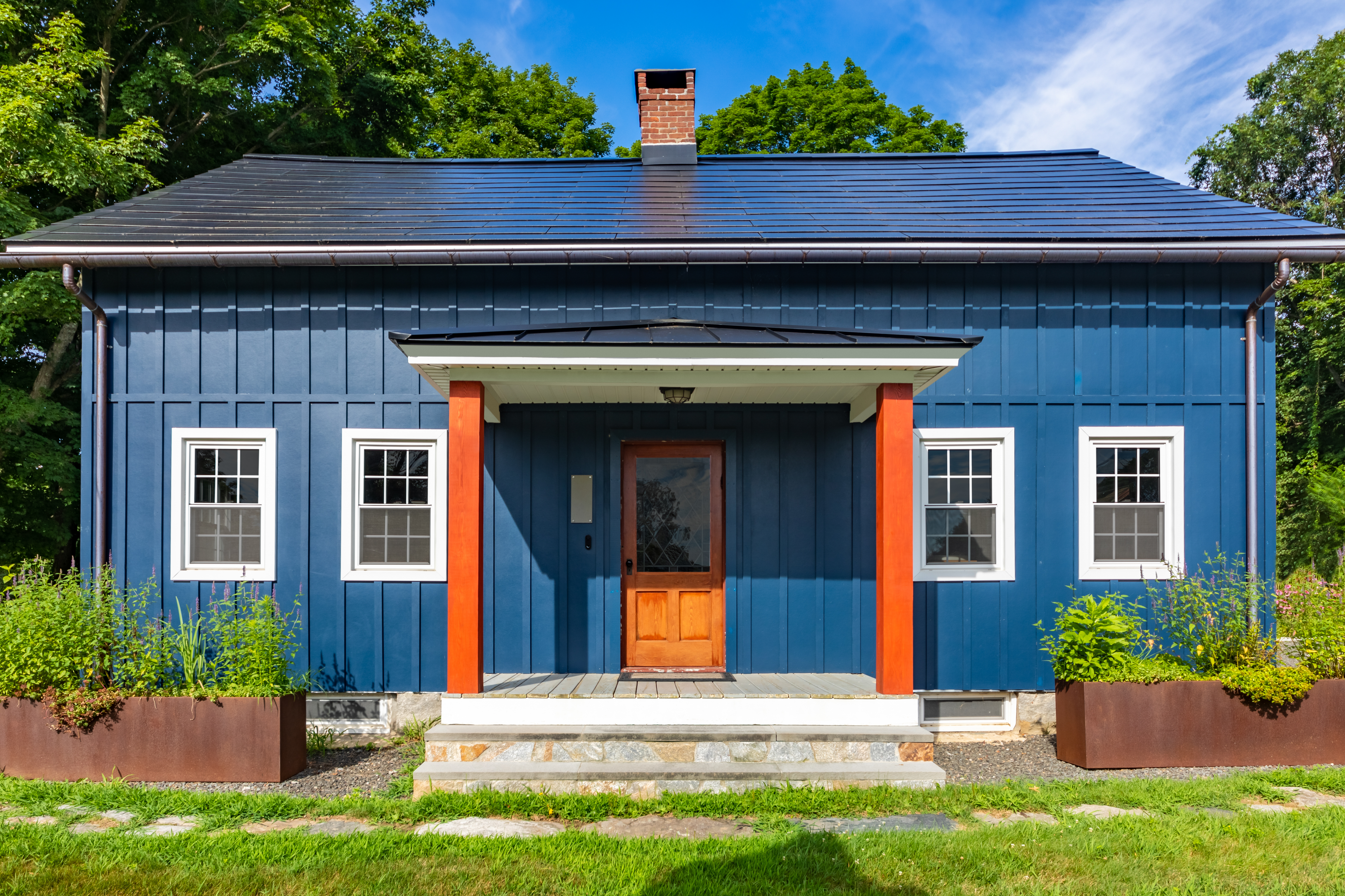 House Style Guide: Modern colonial house clad with Hardie Board and Batten trim in Blue River