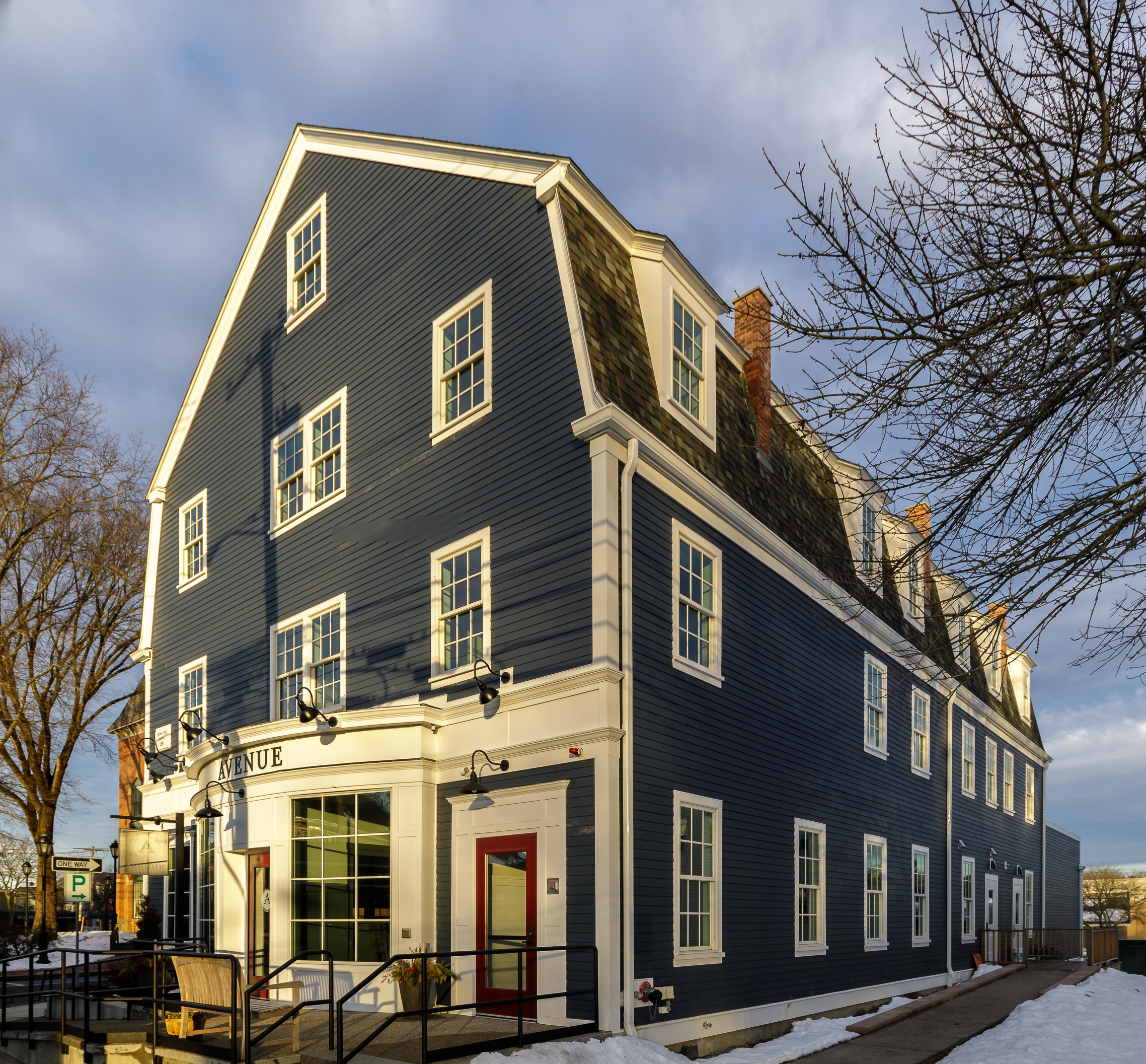 Commercial building in the Dutch Colonial style clad in Deep Ocean Hardie plank lap siding and Arctic White Hardie trim