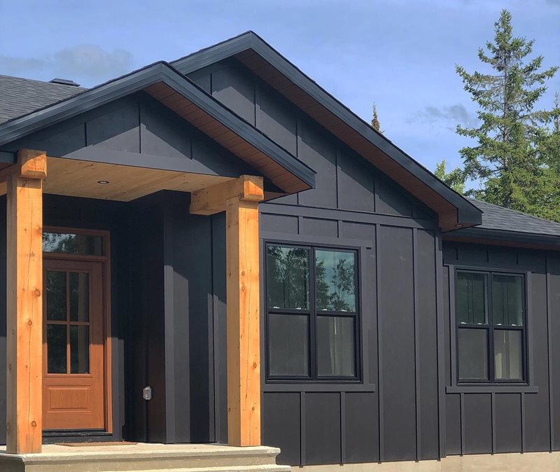 House clad in black Hardie® Panel and Board and Batten Trim