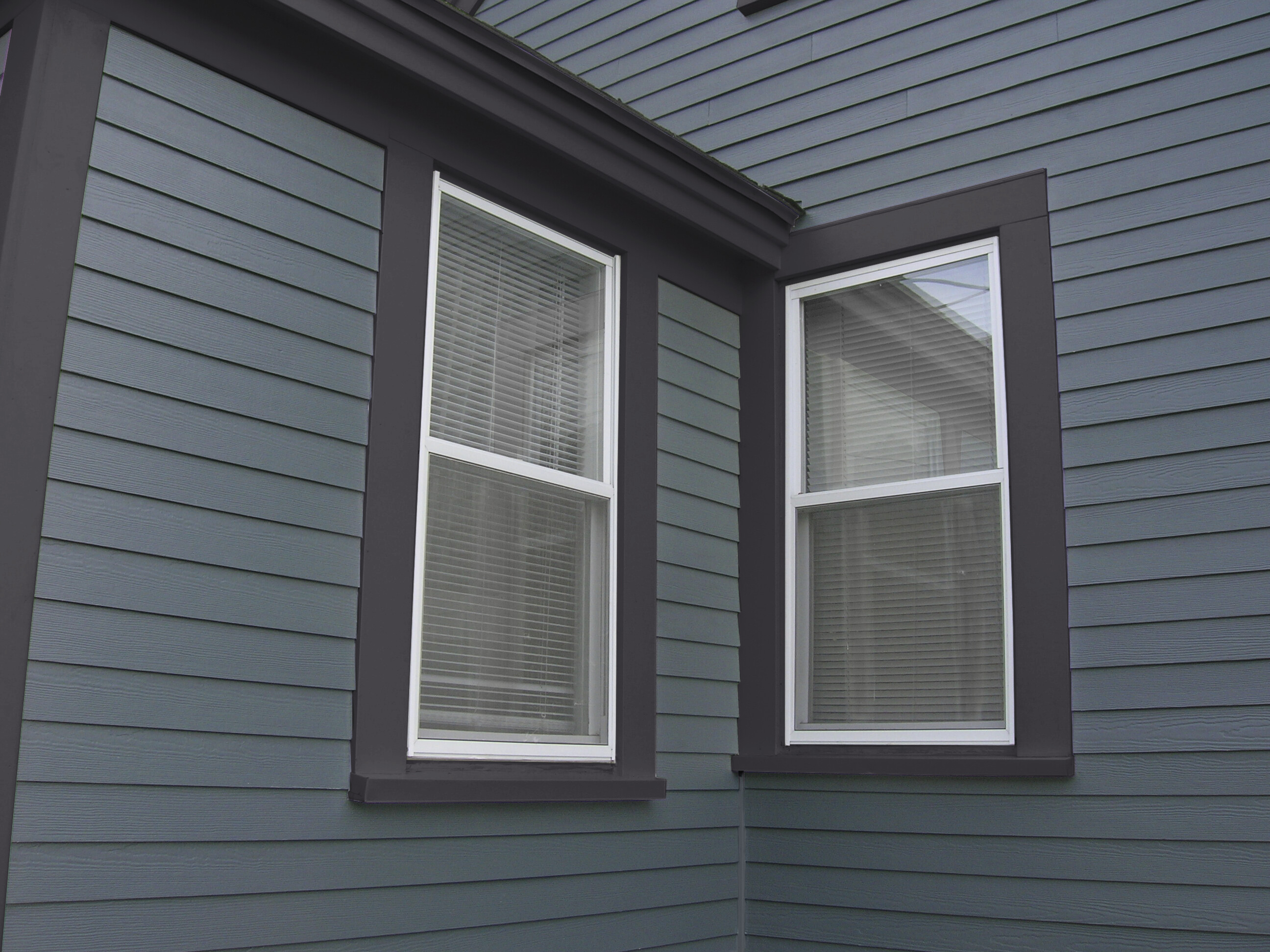 A close up detail of blue Hardie Plank lap with dark blue Hardie Trim 
