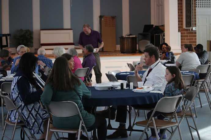 church members at tables talking