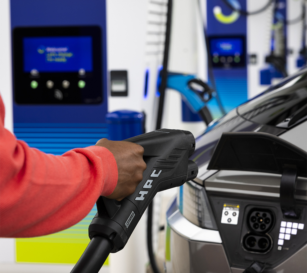 A customer charging his electric vehicle
