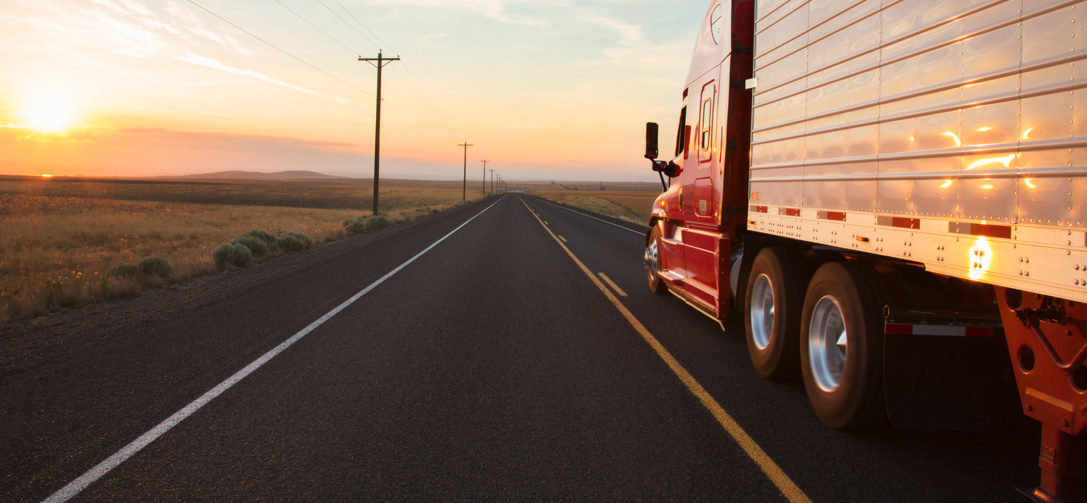 truck-driving-down-highway-landscape.jpg