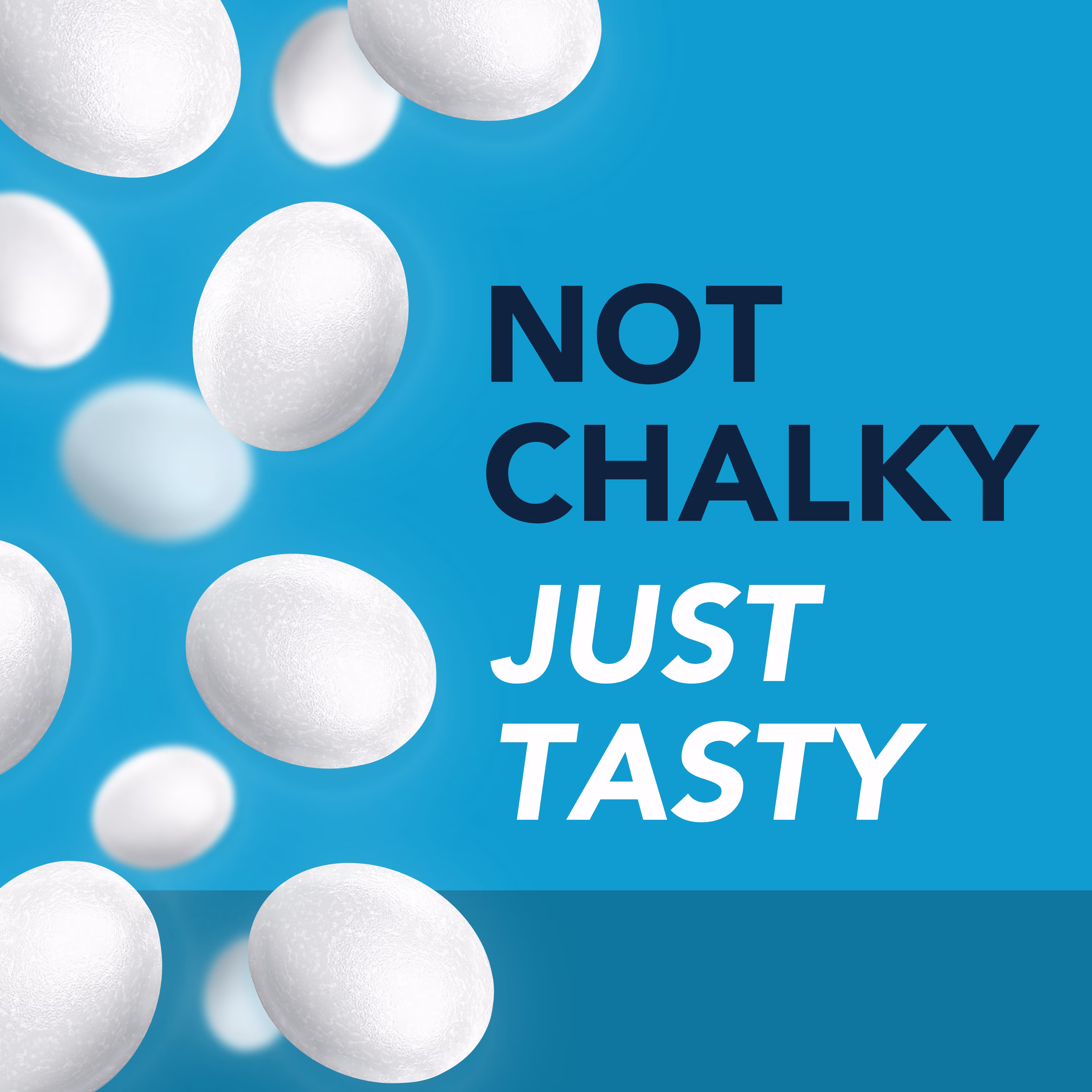 Text on a blue background "NOT CHALKY JUST TASTY" surrounded by many white lozenges.