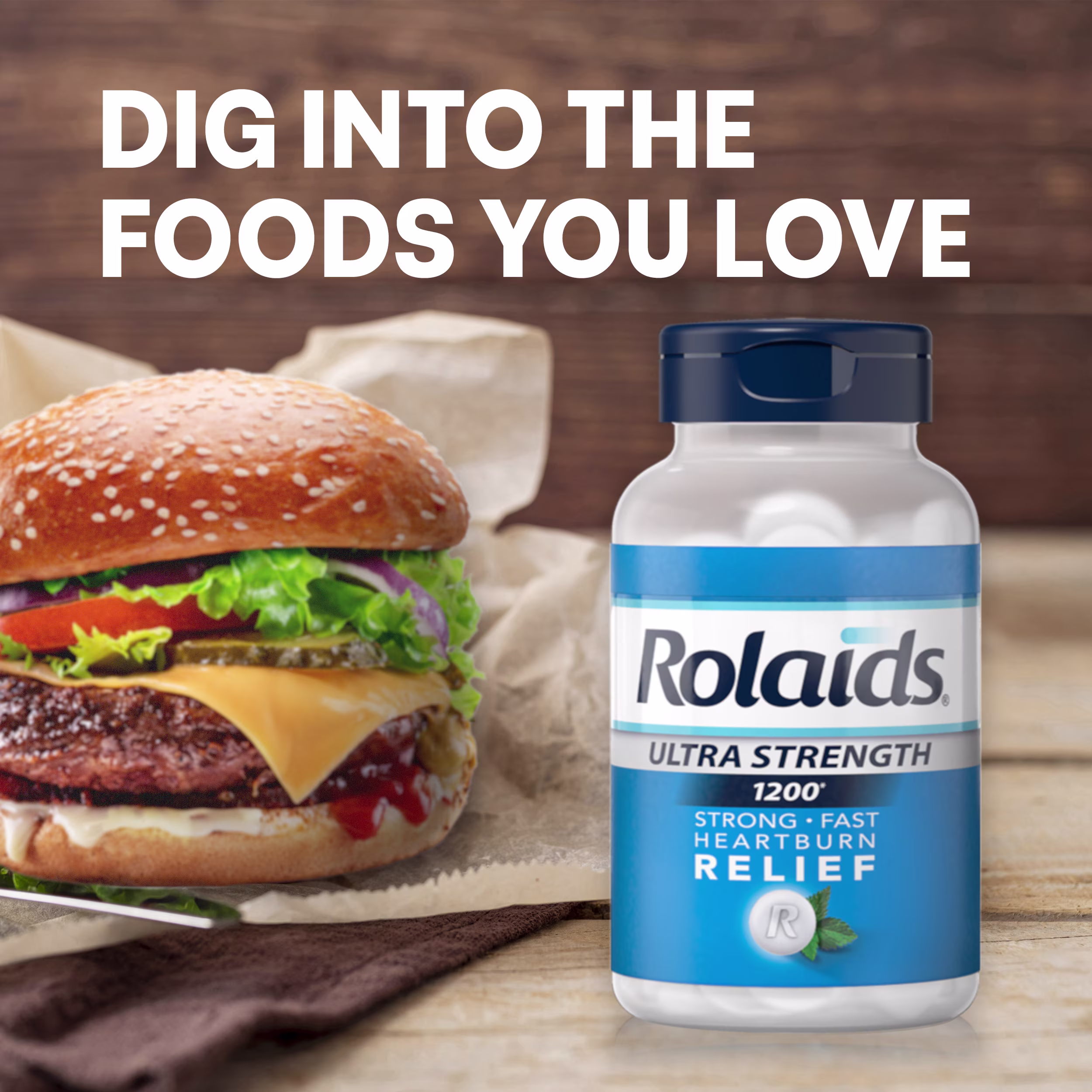 Rolaids Ultra Strength 1200 bottle next to a cheeseburger on a wooden table, with headline text reading "DIG INTO THE FOODS YOU LOVE."