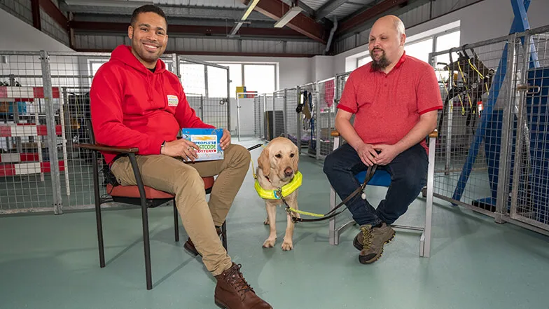 Danyl Johnson sat next to guide dog owner Fraser and guide dog Mabel